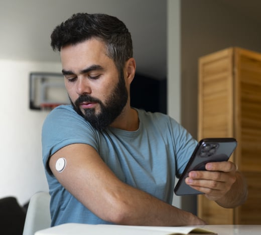 diabetic-man-checking-glucose-patch-sensor